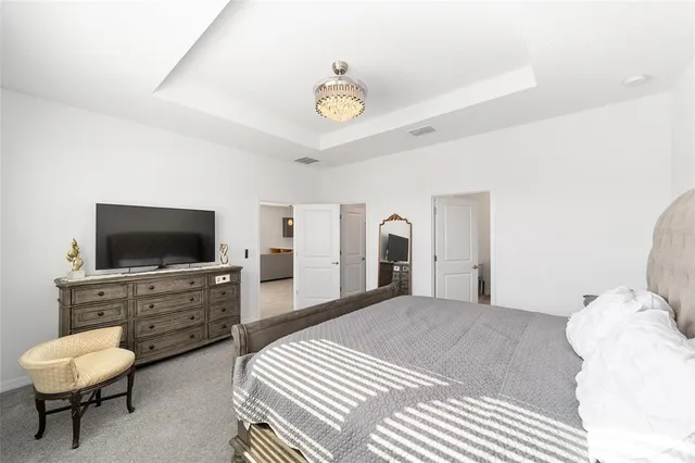 a bedroom with furniture and a flat screen tv