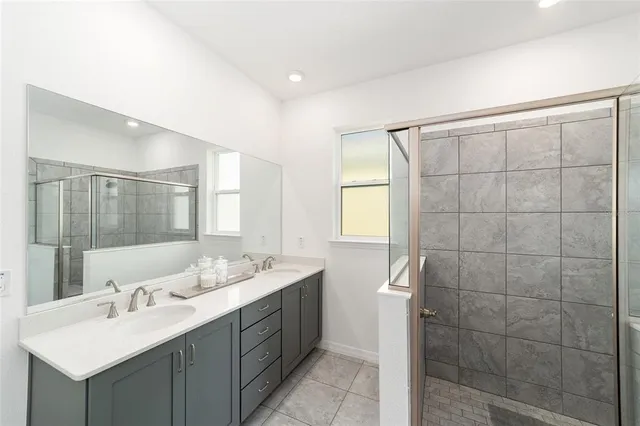 a bathroom with a double vanity sink mirror and double