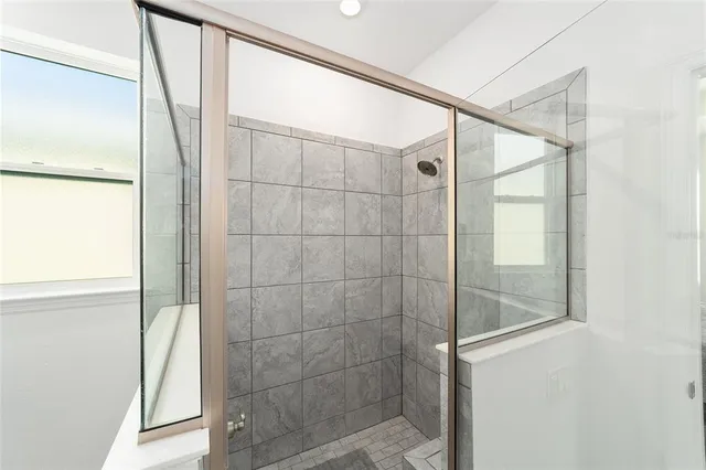 a bathroom with a glass shower door