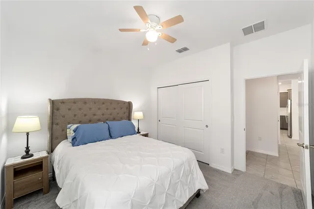 a bedroom with a bed and a lamp