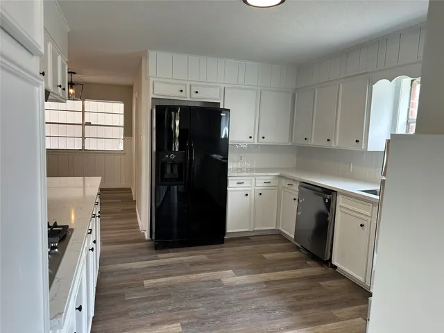 a kitchen with a refrigerator and a stove