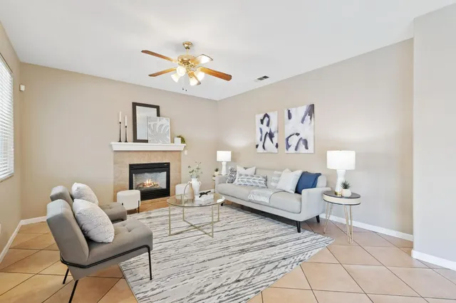a living room with furniture and a fireplace