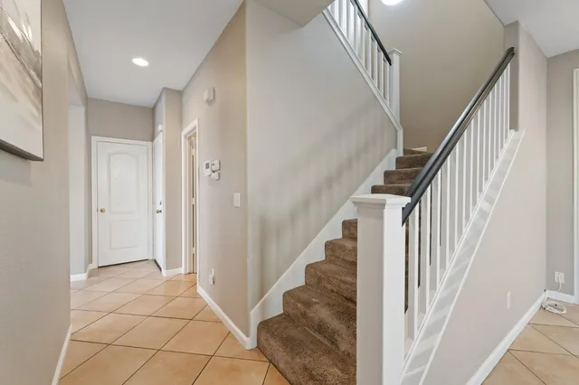 a view of a hallway with wooden floor and entryway