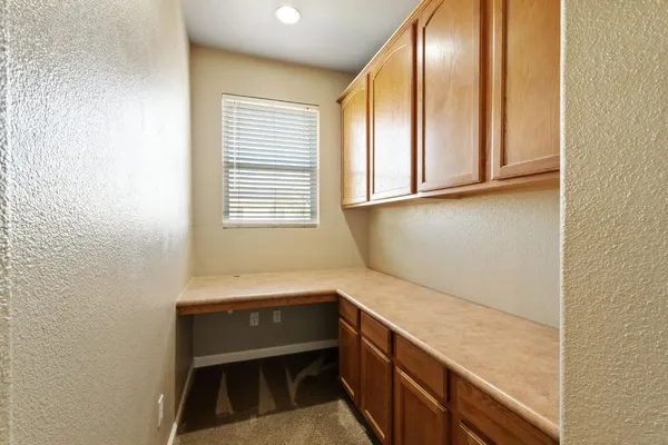 a bathroom with a toilet sink vanity and mirror