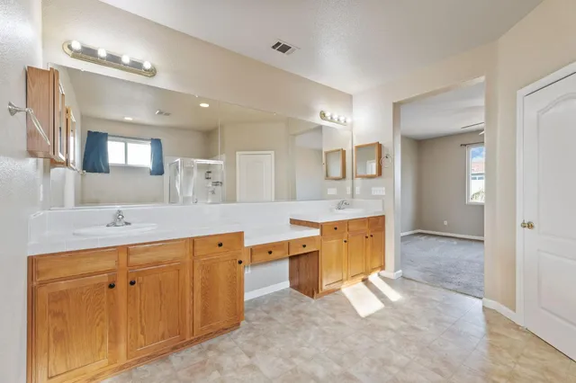 a large bathroom with a large mirror vanity and sink