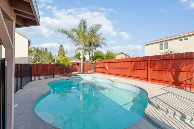a view of a swimming pool with a yard
