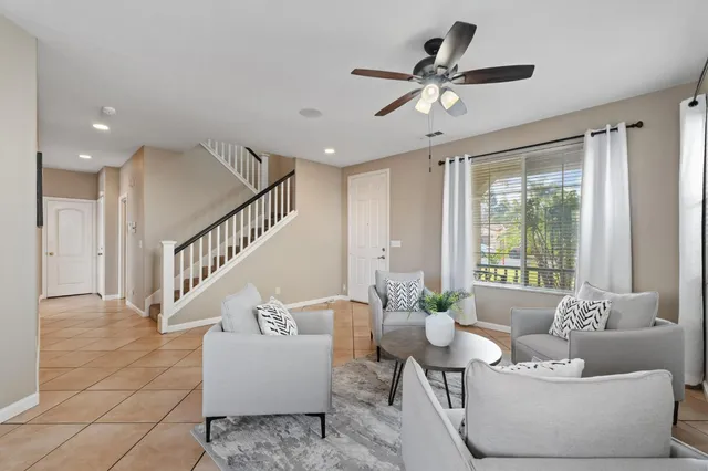 a living room with furniture and a large window