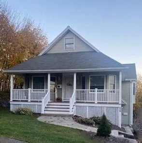 a front view of a house with a garden