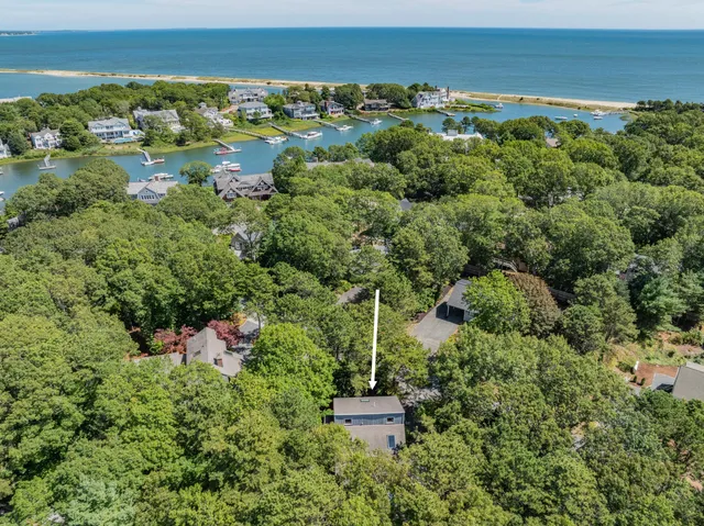 an aerial view of a house with a yard