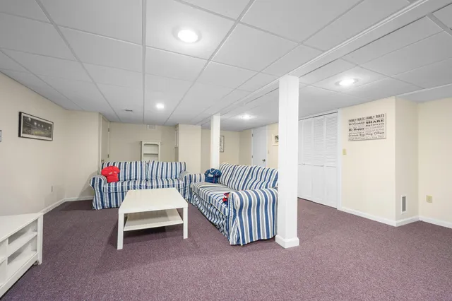 a living room with furniture and a ceiling fan
