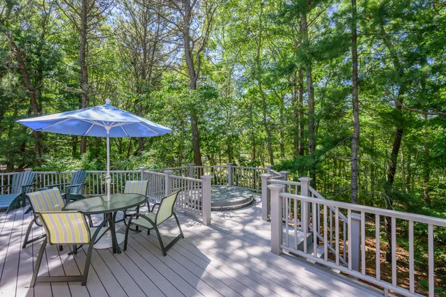 a view of a chair and table on the deck
