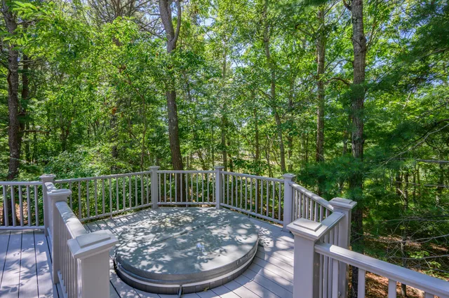 a view of a deck with two chairs and wooden fence