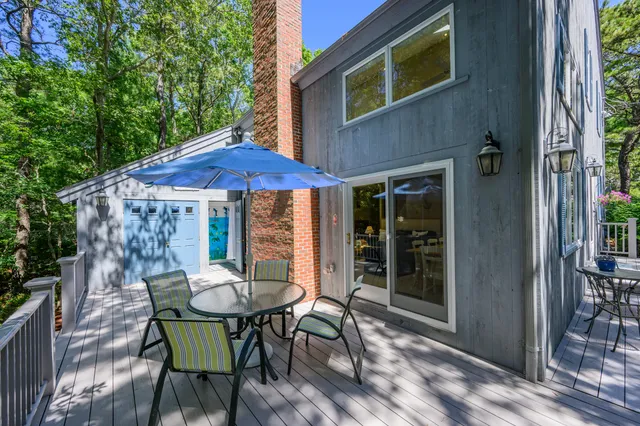 a patio with a table and chairs under an umbrella