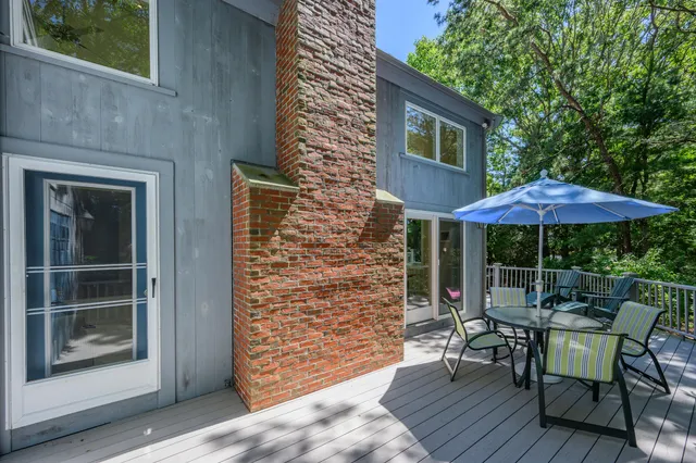 a view of house with backyard outdoor seating and wooden floor