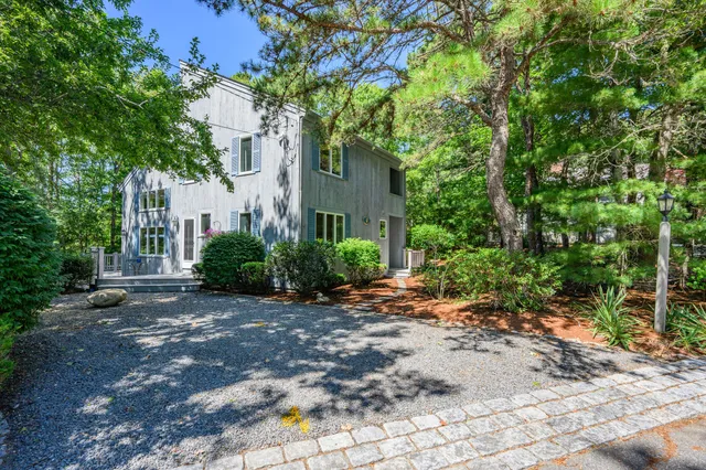 a view of a house with a tree in the background