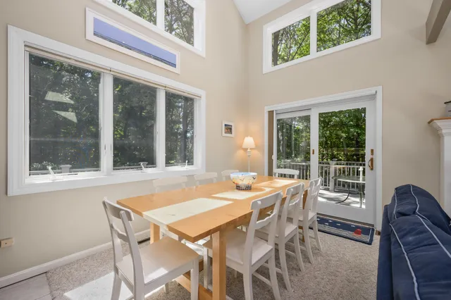 a view of a dining room with furniture large windows and wooden floor