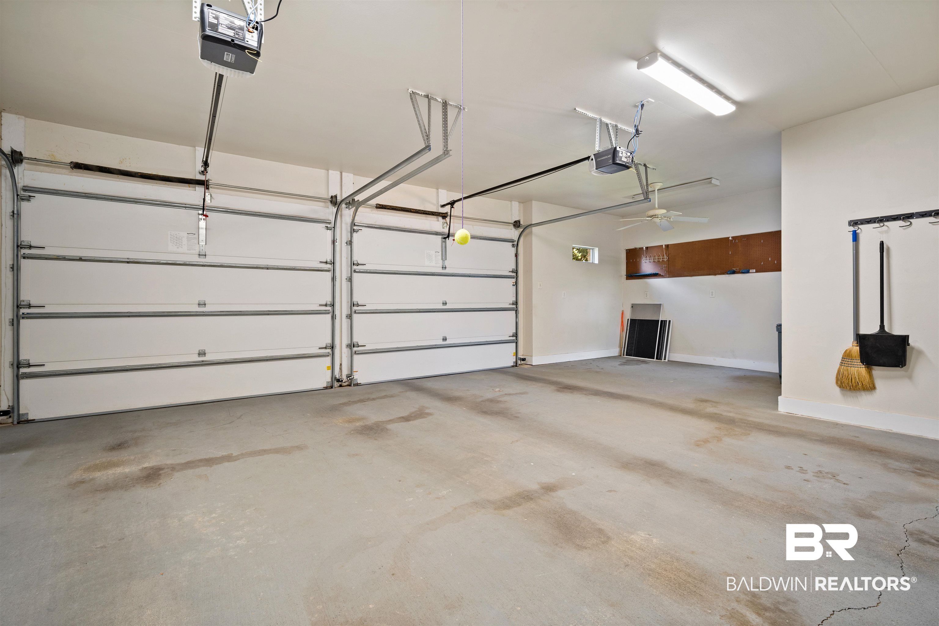 204 General Canby Loop Daphne, AL 36527 - Photo 35 of 36 Garage with ceiling fan and a garage door opener