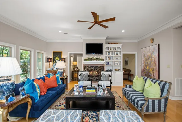 a living room with furniture fireplace and a window
