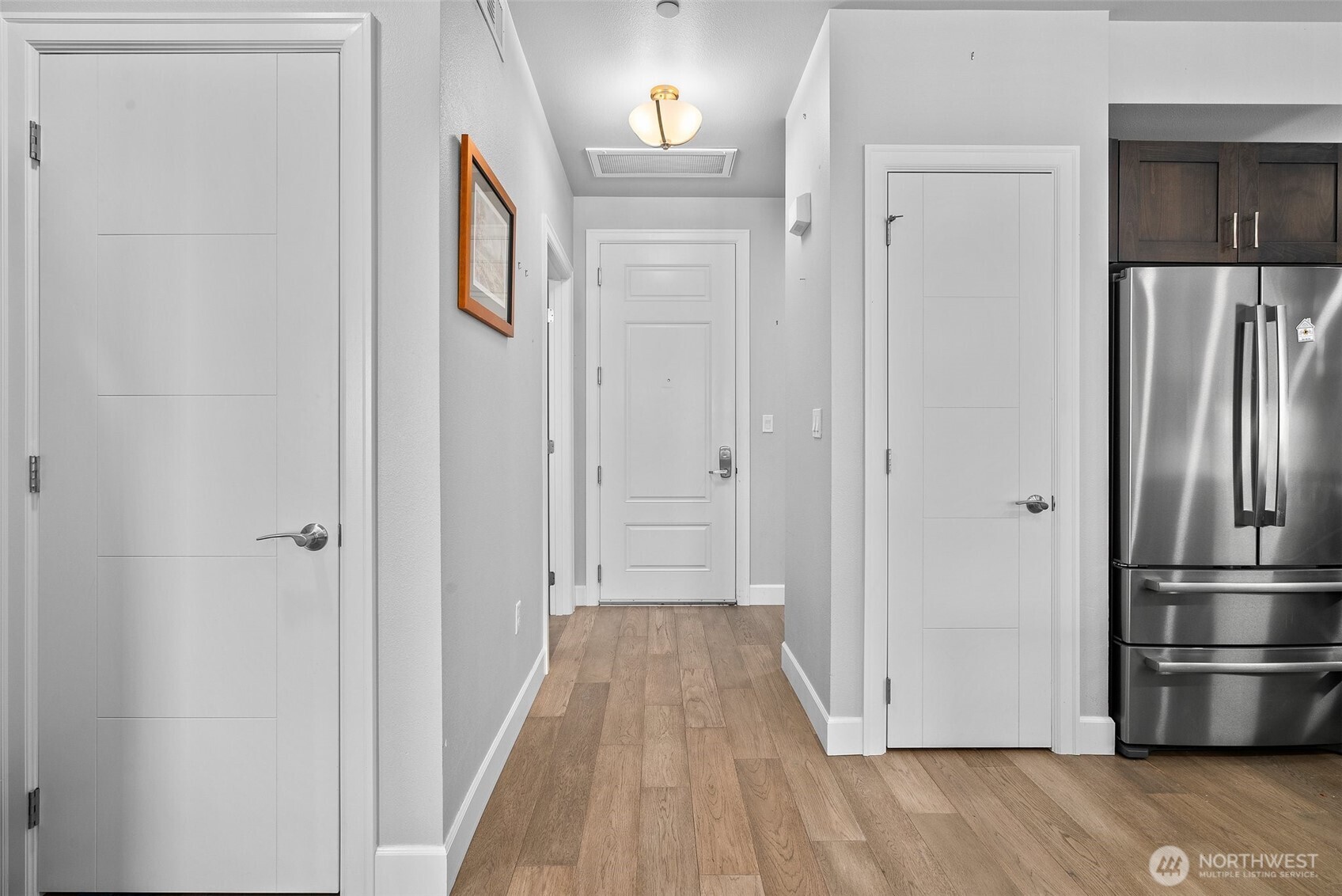 4961 Main Street, Unit 710 Tacoma, WA 98407 - Photo 5 of 24 a view of hallway with wooden floor