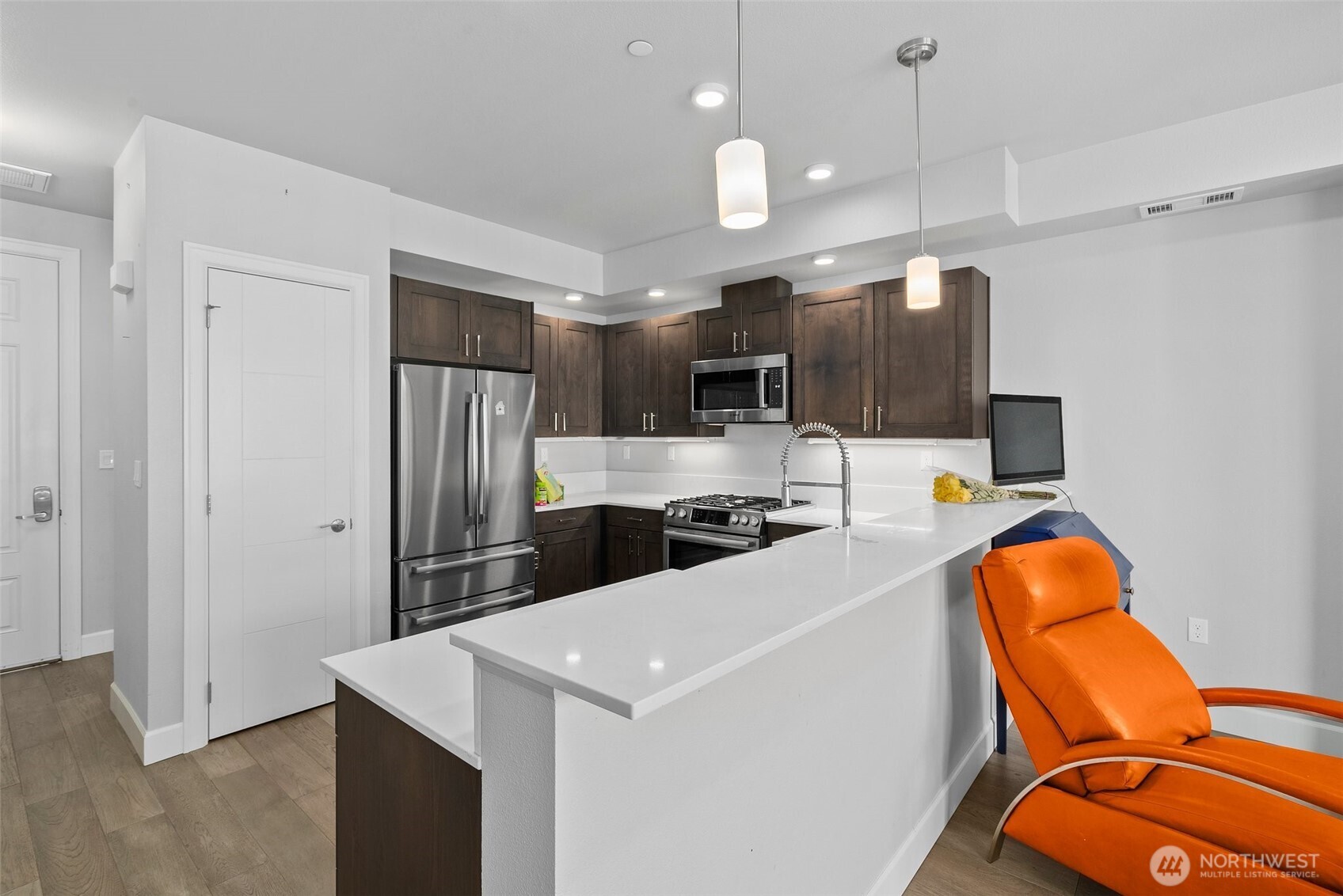 4961 Main Street, Unit 710 Tacoma, WA 98407 - Photo 7 of 24 a kitchen with stainless steel appliances a refrigerator sink and microwave