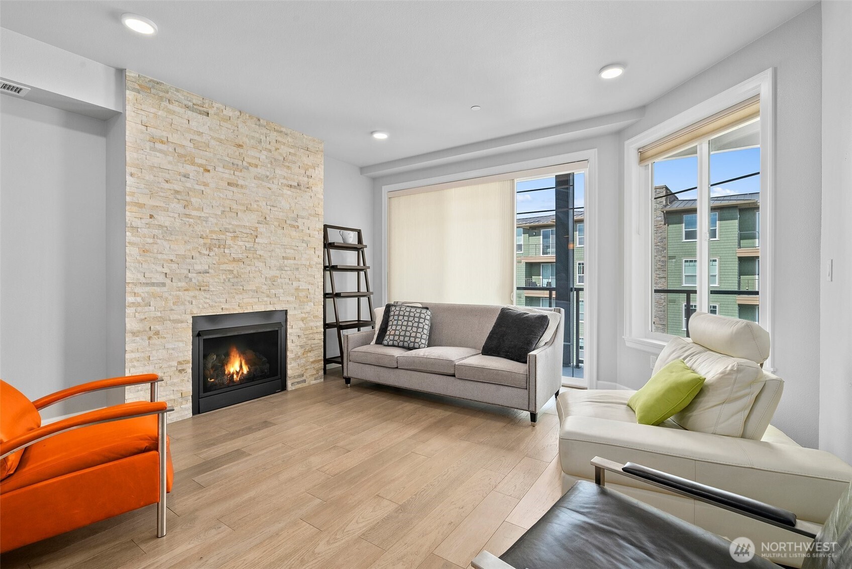4961 Main Street, Unit 710 Tacoma, WA 98407 - Photo 9 of 24 a living room with furniture and a fireplace