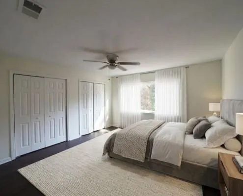 a bedroom with a bed and a window