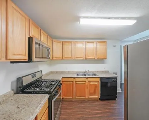 a kitchen with a sink stove and cabinets