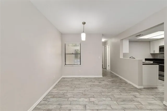 a view of a kitchen with a sink and a refrigerator