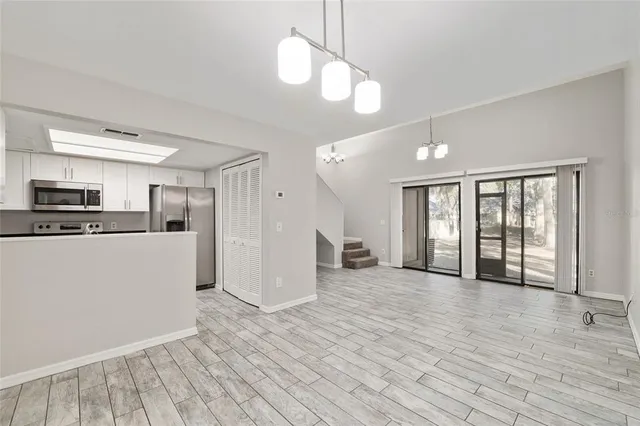 a view of a kitchen with wooden floor and a kitchen