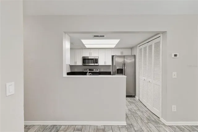 a kitchen with stainless steel appliances a refrigerator and a stove