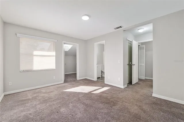 an empty room with windows and closet