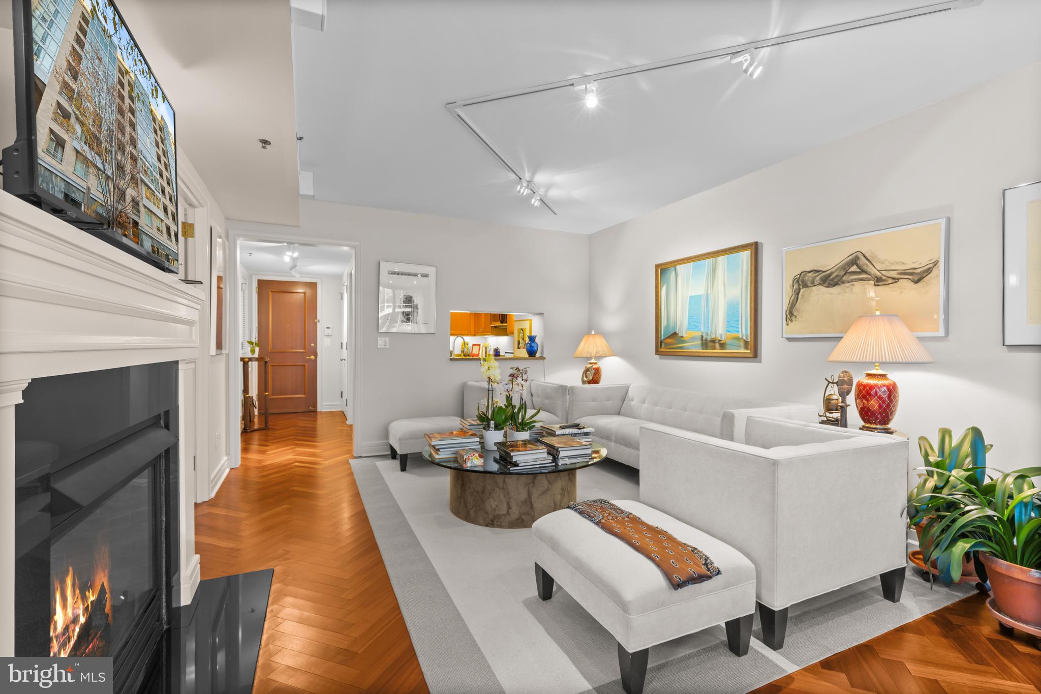 1111 23rd Street Northwest, Unit 4G Washington, DC 20037 - Photo 15 of 35 a living room with furniture and a fireplace