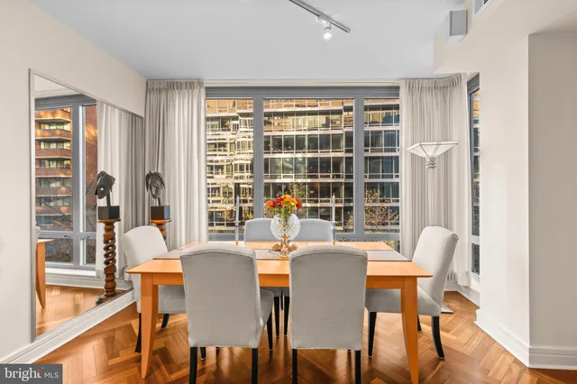 a dining room with furniture and a large window