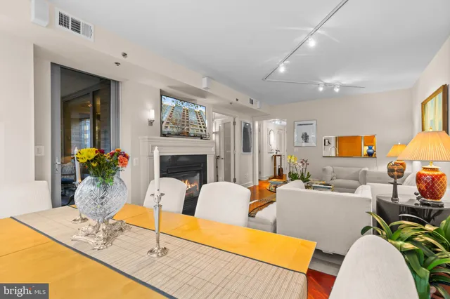 a living room with furniture a fireplace and a table