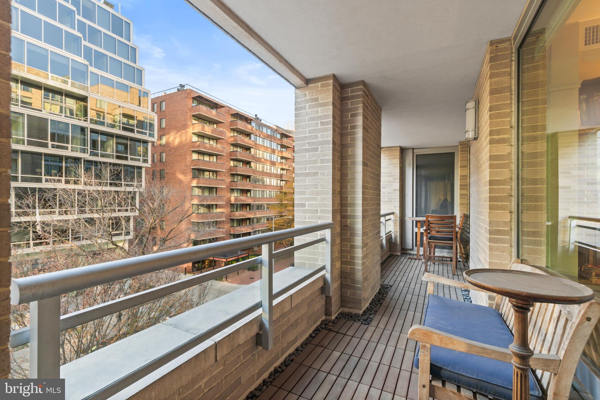 1111 23rd Street Northwest, Unit 4G Washington, DC 20037 - Photo 21 of 35 a view of a balcony with chair and table