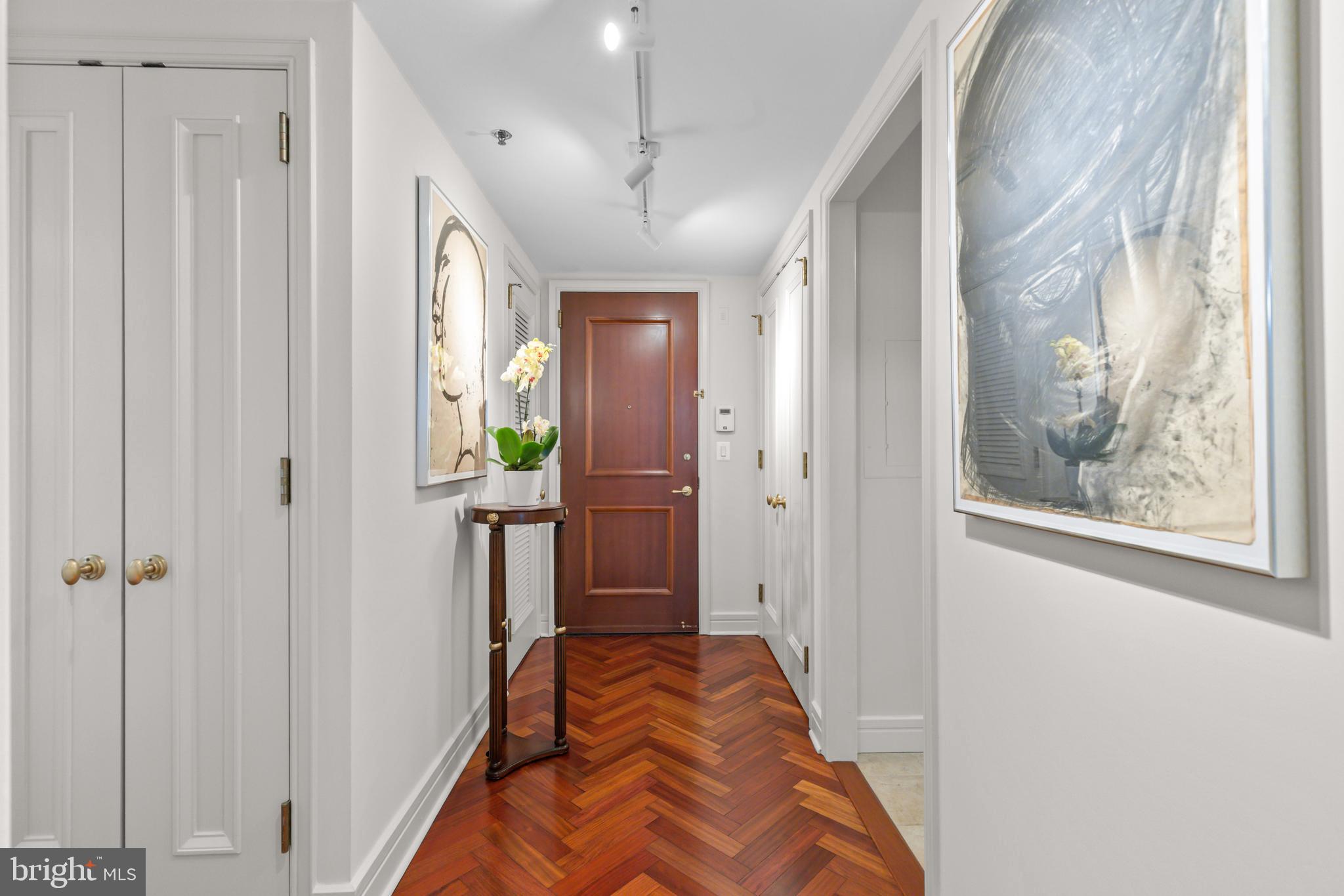 1111 23rd Street Northwest, Unit 4G Washington, DC 20037 - Photo 6 of 35 a view of a hallway with wooden floor and windows