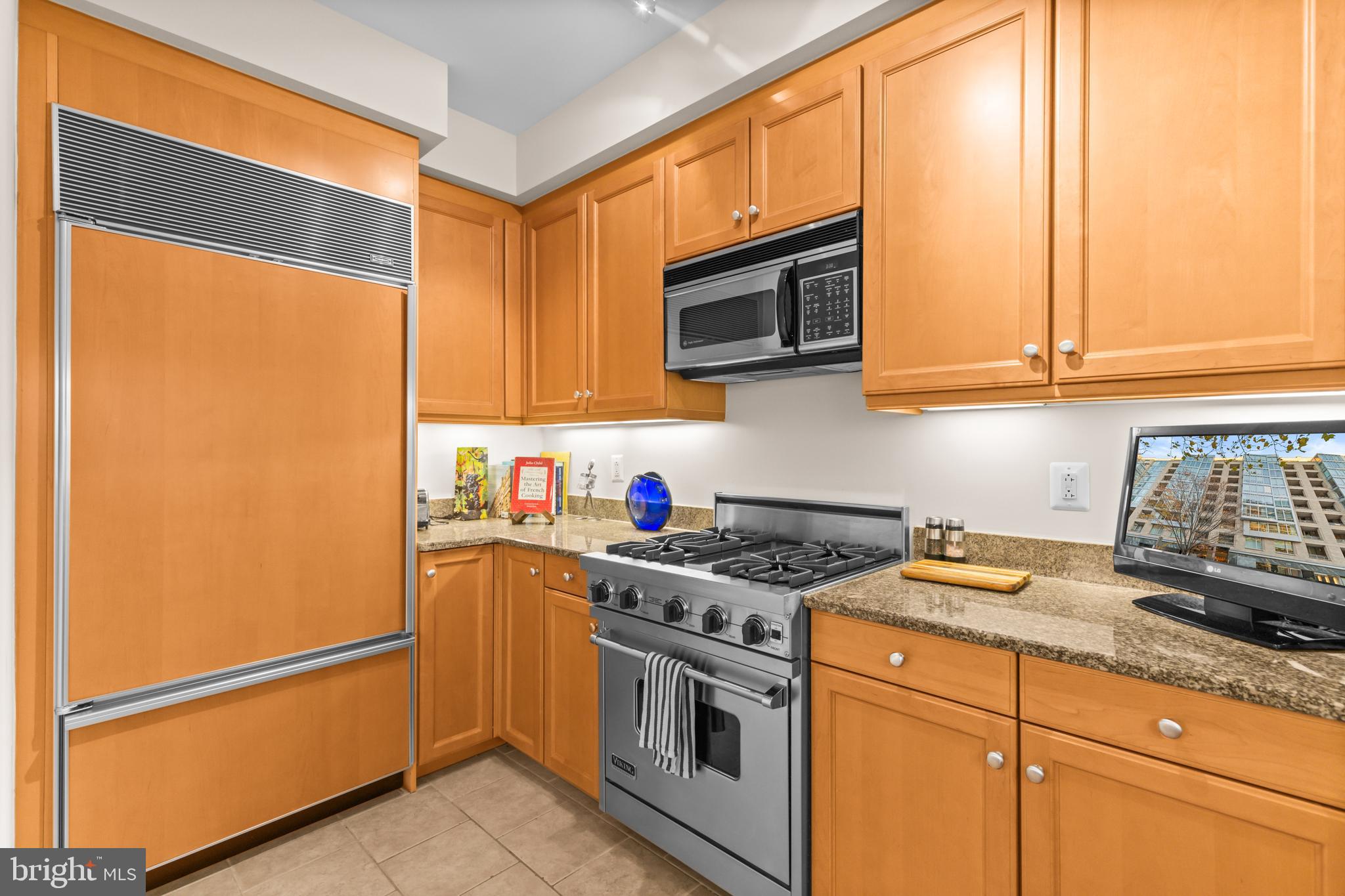 1111 23rd Street Northwest, Unit 4G Washington, DC 20037 - Photo 10 of 35 a kitchen with stainless steel appliances granite countertop a refrigerator sink and cabinets