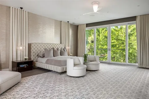 a bedroom with a bed and large window