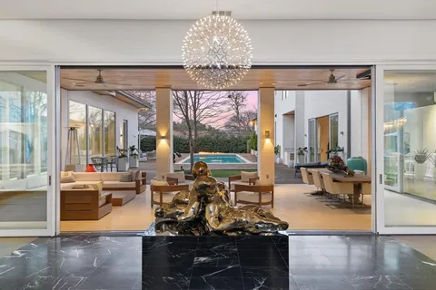 a view of a dining room with furniture wooden floor and chandelier