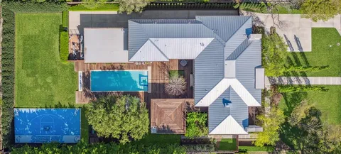 a living room with patio furniture and a large window