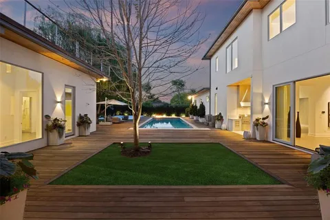 a view of swimming pool with lawn chairs yard