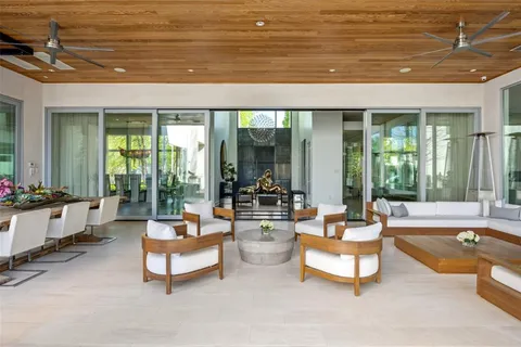 a living room with furniture and floor to ceiling windows