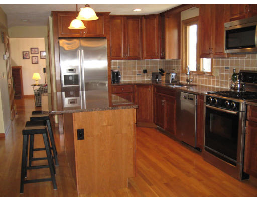 5 Freeman Road Chelmsford, MA 01824 - Photo 3 of 21 a kitchen with stainless steel appliances granite countertop a refrigerator a stove and a sink