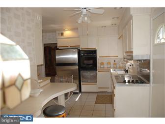 1411 Clements Road Wyncote, PA 19095 - Photo 4 of 12 a kitchen with stainless steel appliances kitchen island granite countertop a refrigerator and a stove