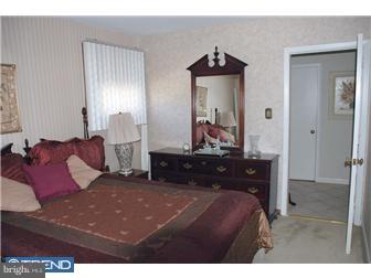 1411 Clements Road Wyncote, PA 19095 - Photo 8 of 12 a bed room with a bed and a mirror