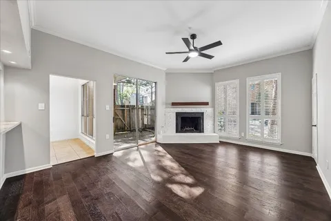 a view of empty room with wooden floor and fireplace