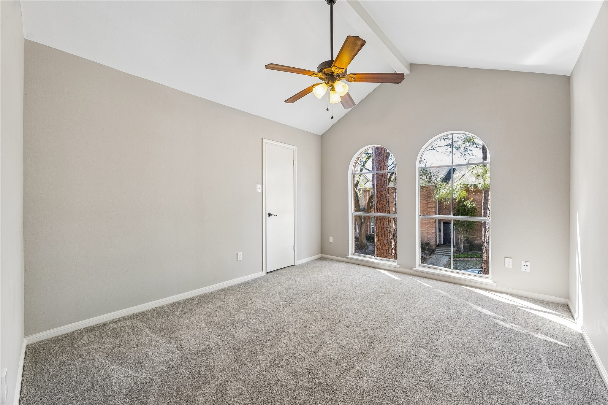 15066 Kimberley Court Houston, TX 77079 - Photo 20 of 27 Secondary bedroom with a vaulted ceiling with ceiling fan and large windows.
