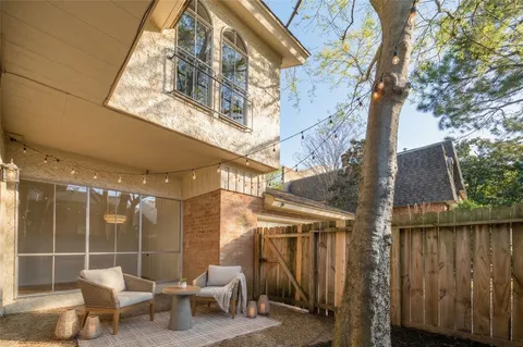 a view of a chairs and table in backyard of the house