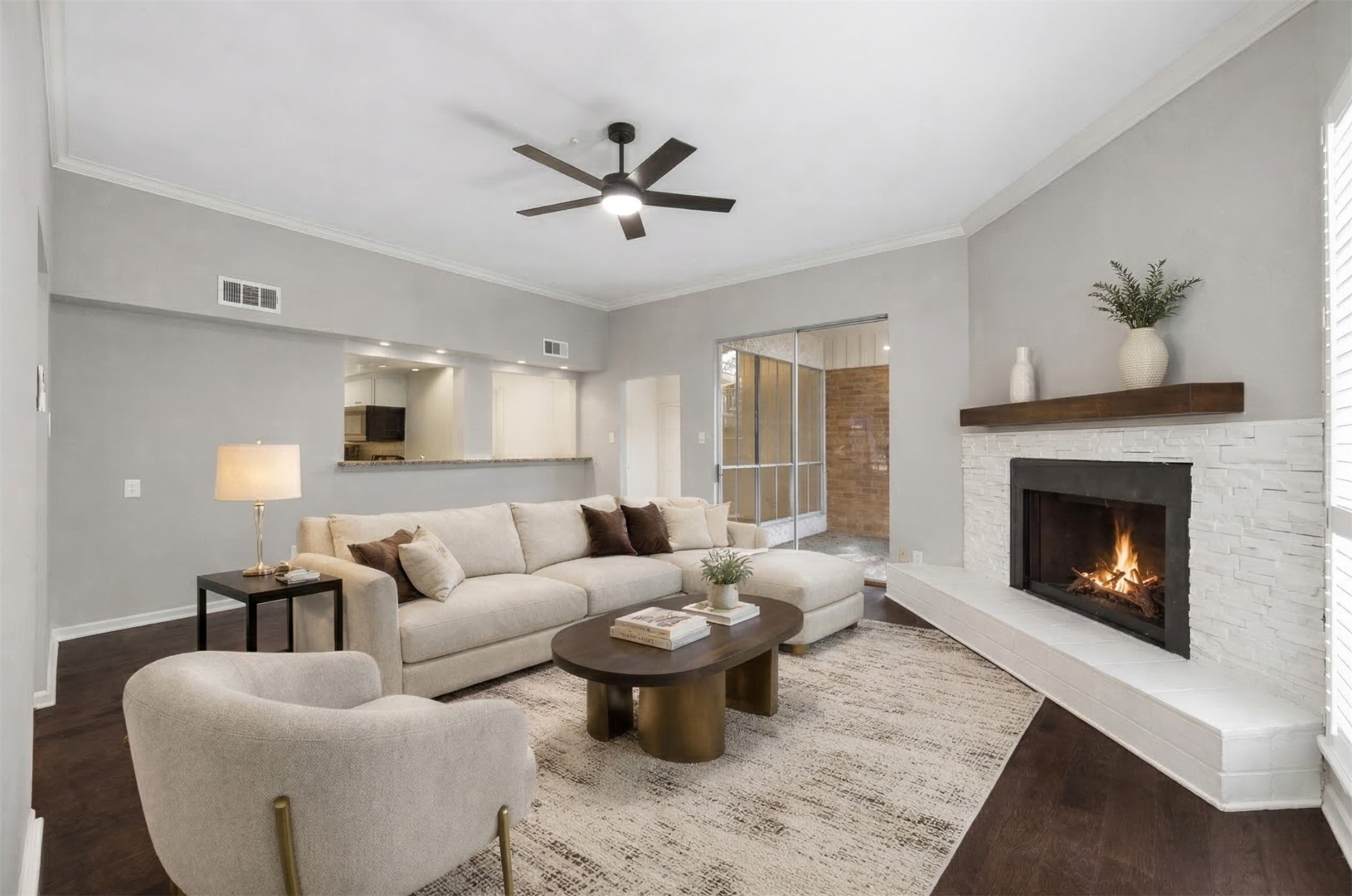 15066 Kimberley Court Houston, TX 77079 - Photo 5 of 27 The kitchen opens to the breakfast room and living room which is anchored by a modernized white stone fireplace. *This photo has been virtually staged.
