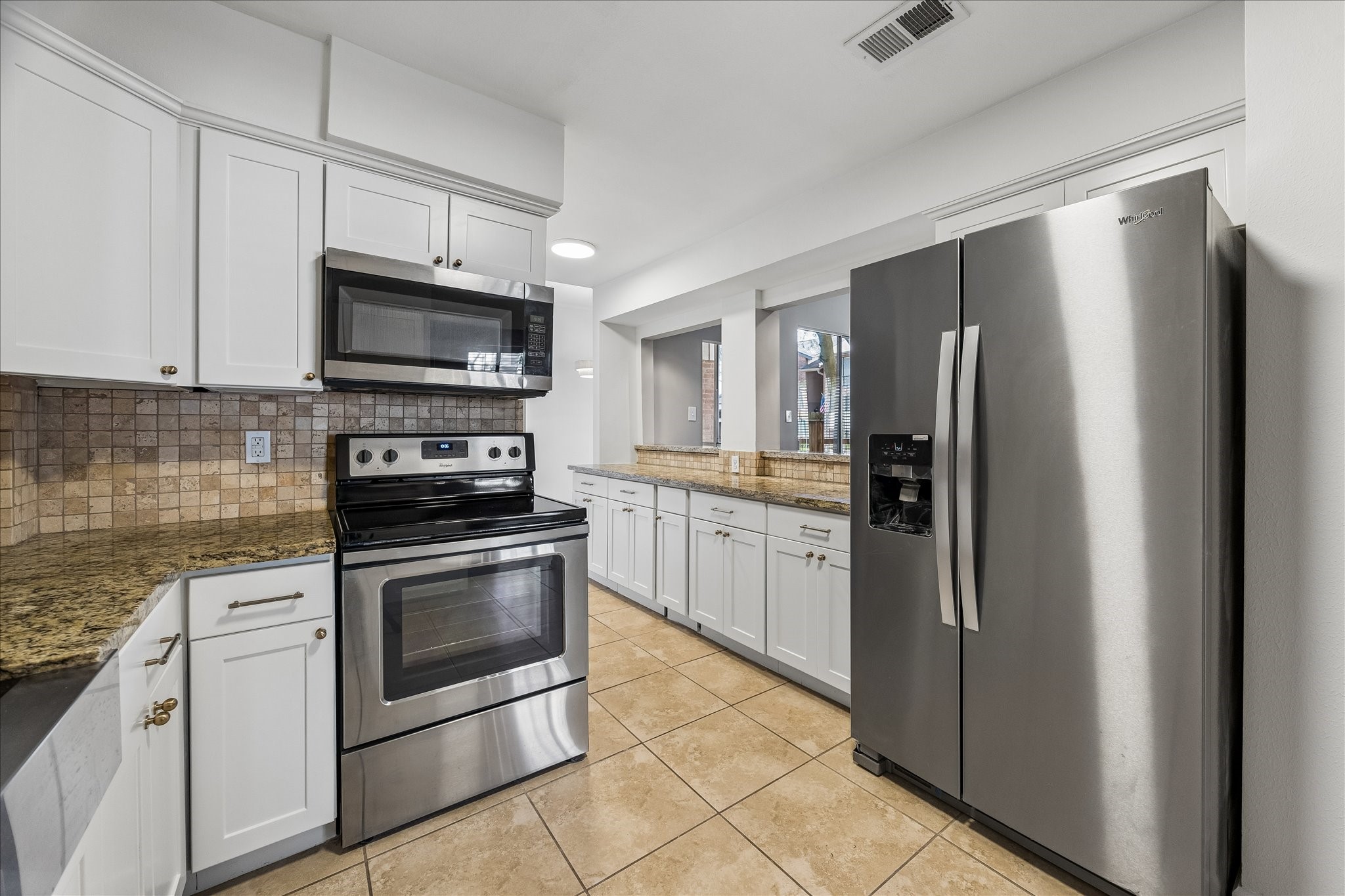 15066 Kimberley Court Houston, TX 77079 - Photo 7 of 27 The kitchen area flows effortlessly into the dining and breakfast rooms, creating a bright and functional space ideal for everyday living and entertaining.